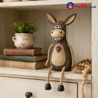 Rustic figurine of a donkey on a plank with rope legs hanging down